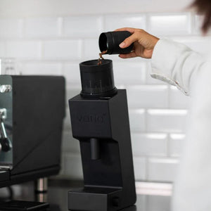 coffee grinder - puring coffee beans into it