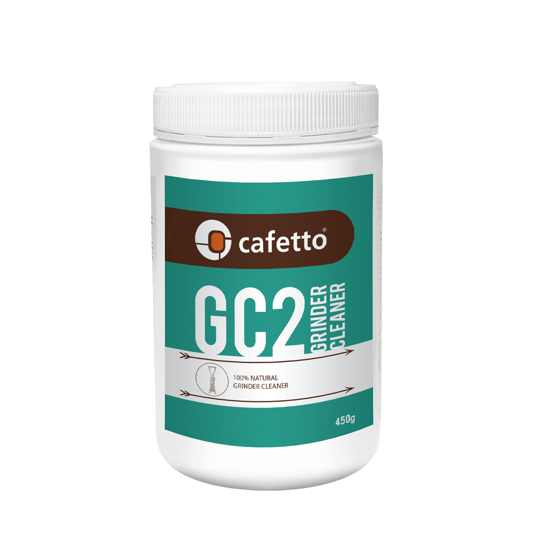 The image displays a pack of coffee grinder cleaner by Caffetto. The pack weights around 450g and it is white. The label is more of a turquoise shade and one of the things written is: 100% natural grinder cleaner. 